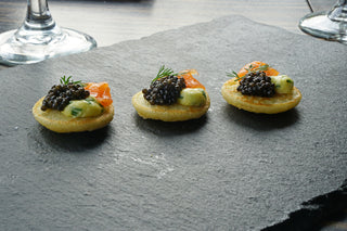 Blinis with herb butter, smoked salmon and caviar